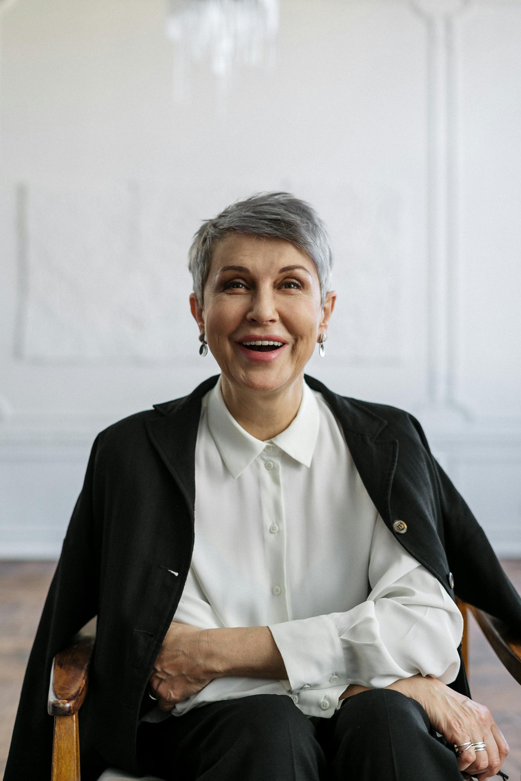 Confident woman smiling in an office, ideal for professional themes.